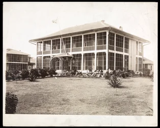 Ein zweistöckiges Haus mit Veranden, mit einer amerikanischen Flagge; in Panama während des Baus des Kanals, 1912